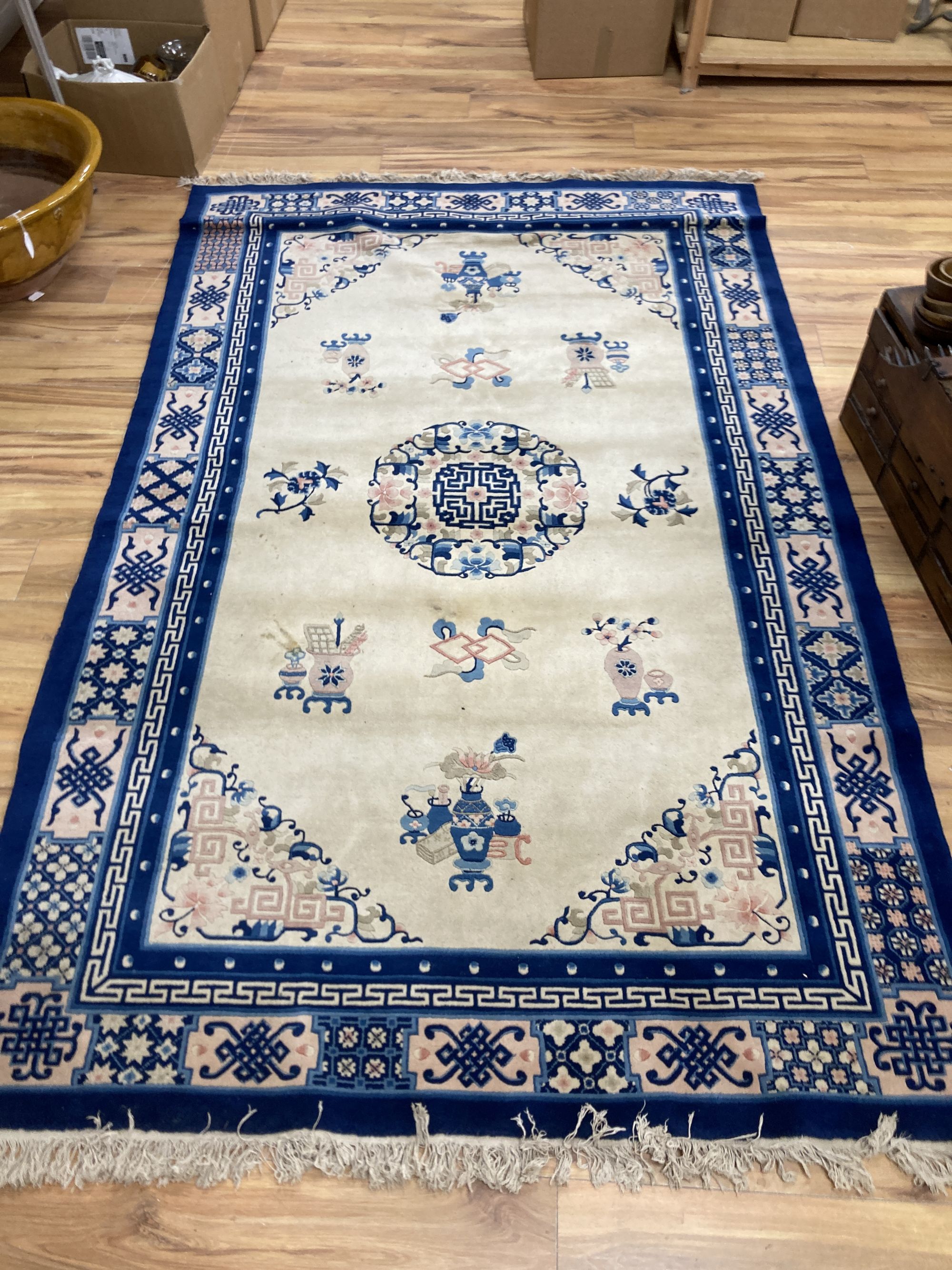 A Chinese wool cream ground rug,